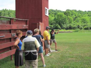 A line of students at a shooting range