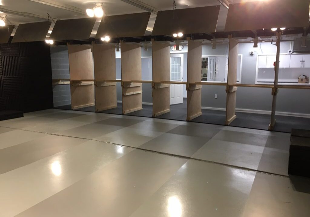 Empty indoor shooting range lanes with partitions